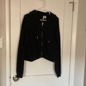 Zip up hoodie with elastic waist band.